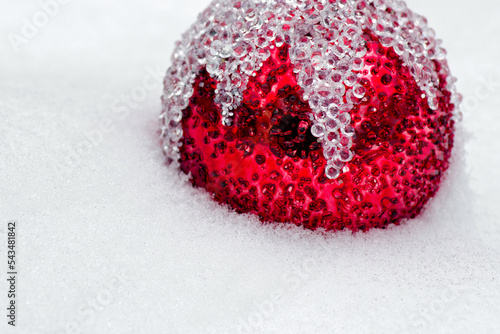 Red christmas ball in snow. Christmas and winter concept