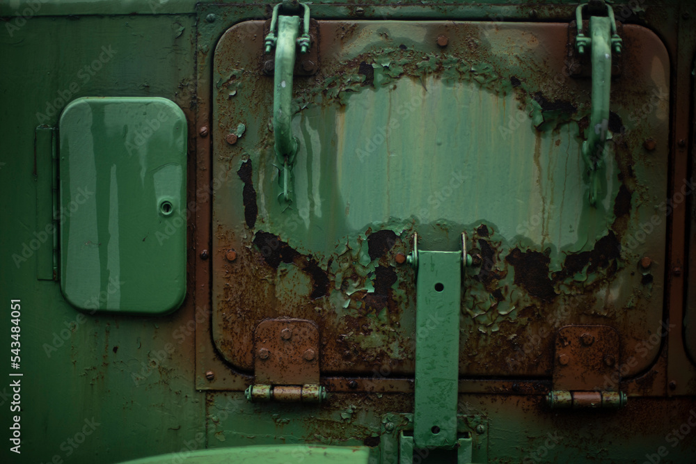 Rust on metal. Field kitchen door. Rust on green paint. Old machine in detail.