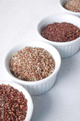 four different types of rice in a bowl on white background 