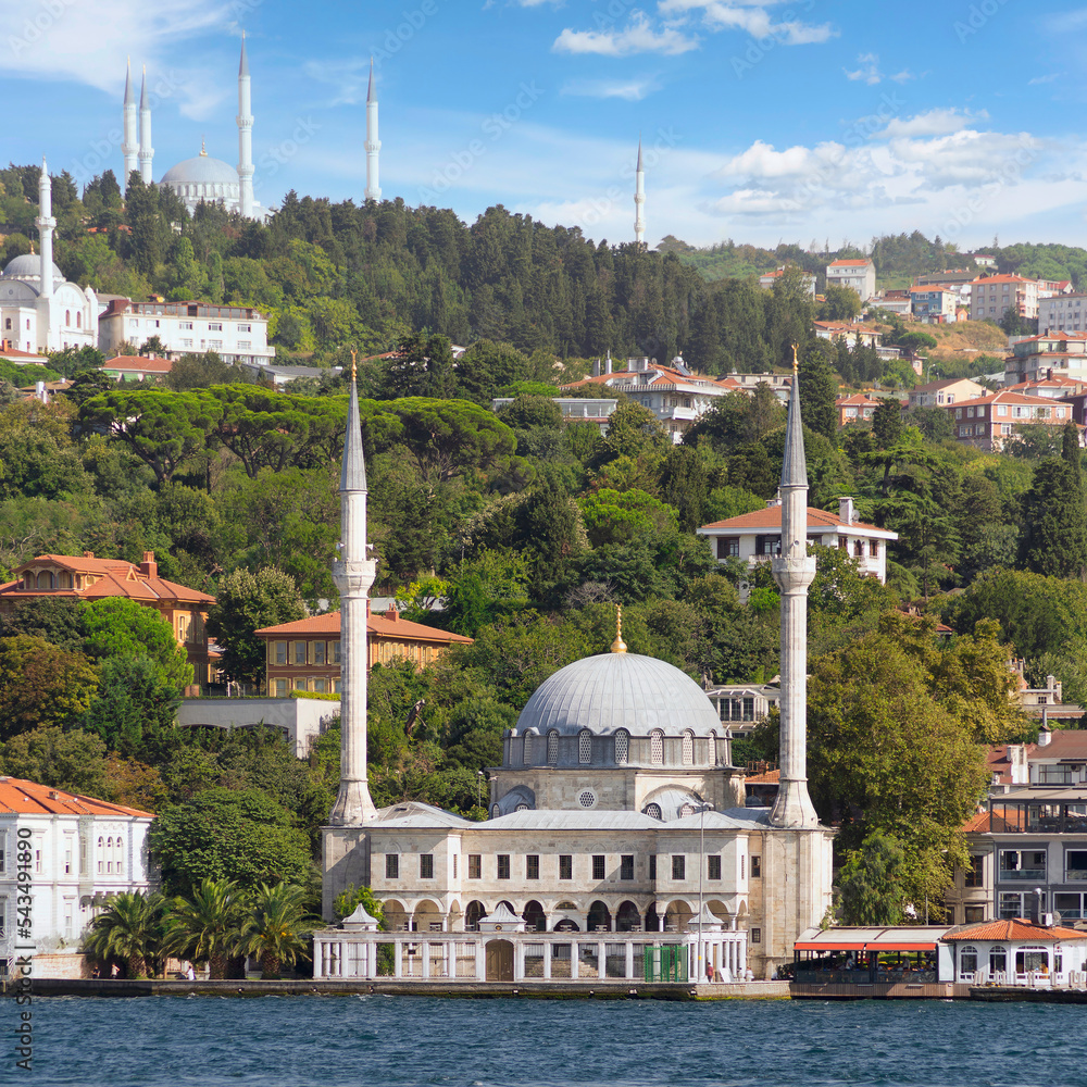 Naklejka premium View from Bosphorus Strait overlooking Beylerbeyi Mosque, or Beylerbeyi Camii, aka Hamid i-Evvel Mosque, suited at the waterside of Beylerbeyi district, Istanbul, Turkey