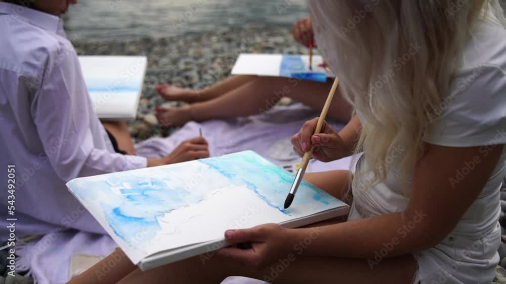Side view of someone painting some picture with a brush isolated Side view of someone painting some picture with a brush isolated