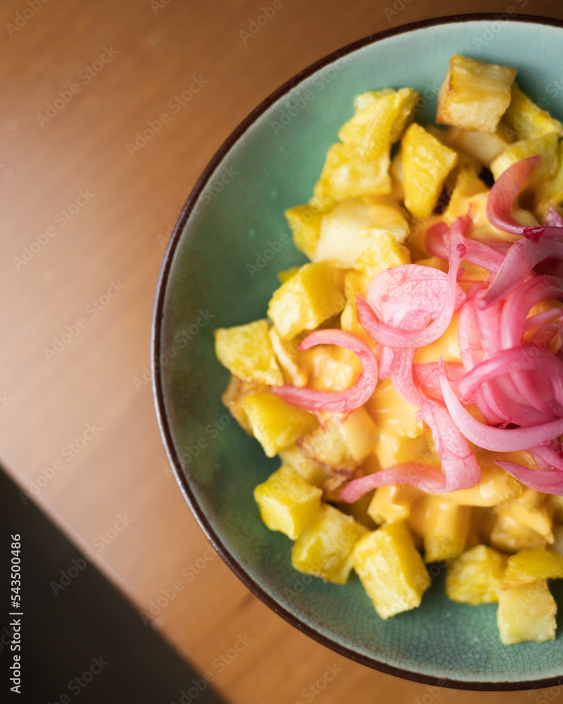 Spicy potatoes with onion and cheese sauce Spicy potatoes with onion and cheese sauce