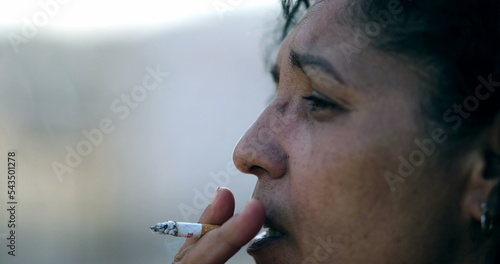 Sad depressed woman smoking cigarette. Real expression, tired person