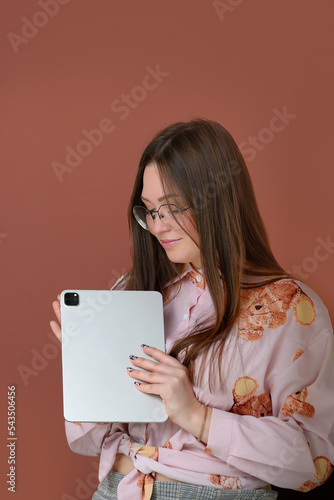 young beautiful girl freelancer with a graphics tablet