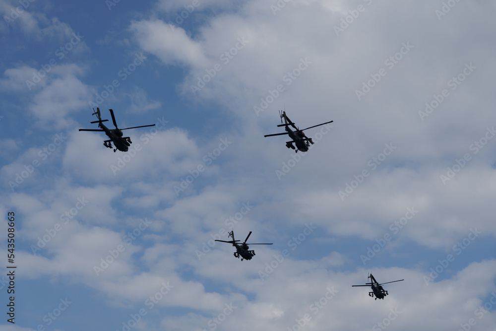 Boeing AH-64 attack helicopters on formation during an air show. Greek ...