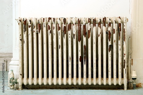 Antique radiator with peeling paint.