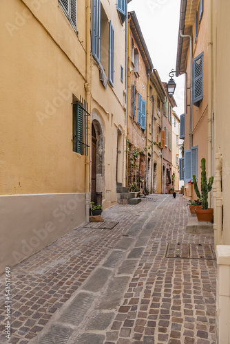 Narrow and colorful medieval street in Cannes Old town on the hill Suquet. Cannes, Cote d'Azur, France.