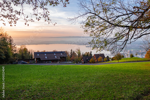 Field on a hill with lake down below on sunset