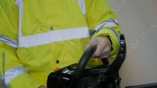 Worker In Reflective Uniform With Chainsaw