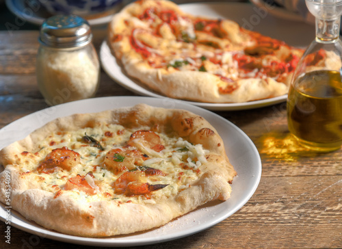 Side view of  BBQ shrimp and chicken pizza .
