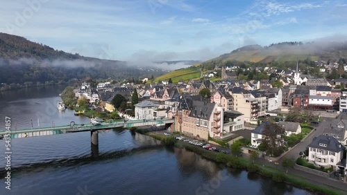 Aerial Drone Shot in autumn of Traben-Trarbach with Morning Fog. River Moselle in early fall, Germany. Moselland. photo