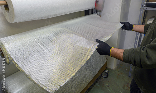 Installation of fiberglass sheets in various sizes ready for the creation of industrial composite material. photo