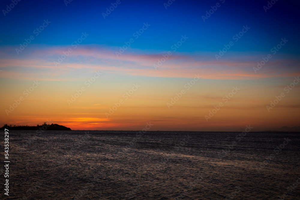 Blue sky with yellowish sunset on the beach