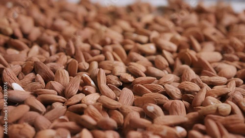 Almonds on a vibrating sorting machine in an industrial food processing facility. Slow motion footage photo