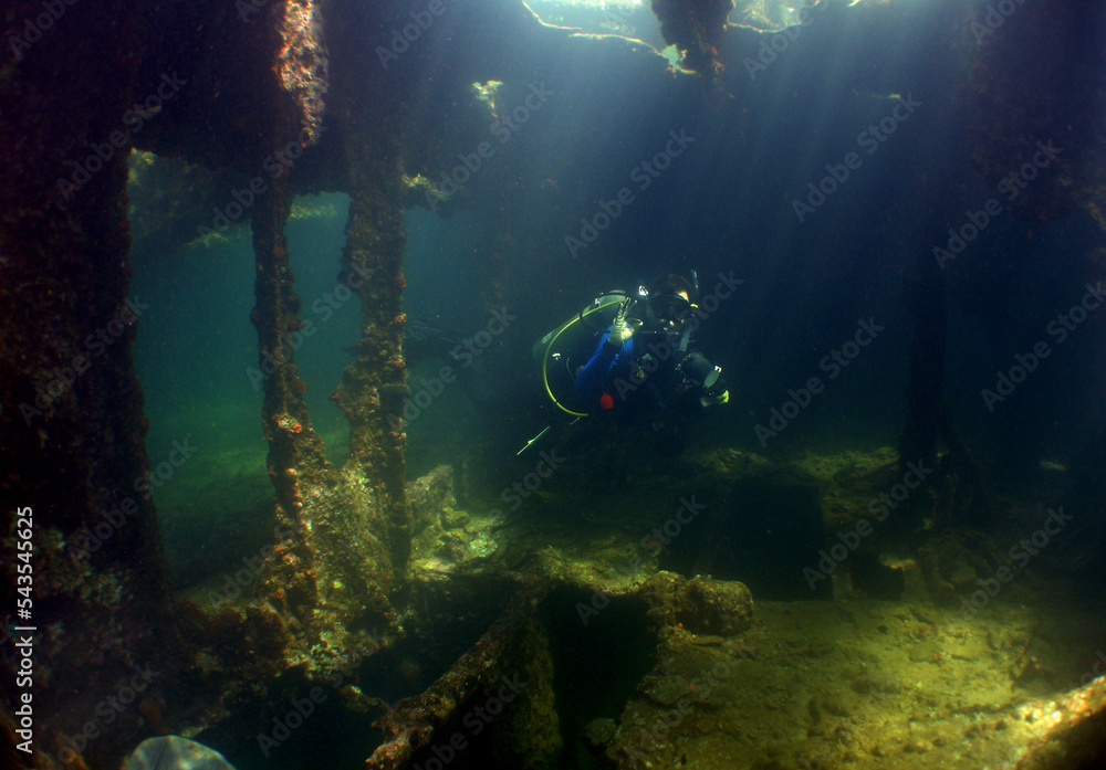underewater scene , scuba diver and ship wreck , caribbean island