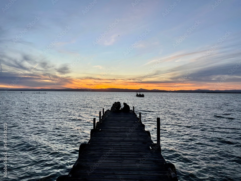 sunset on the pier in albufera spain 