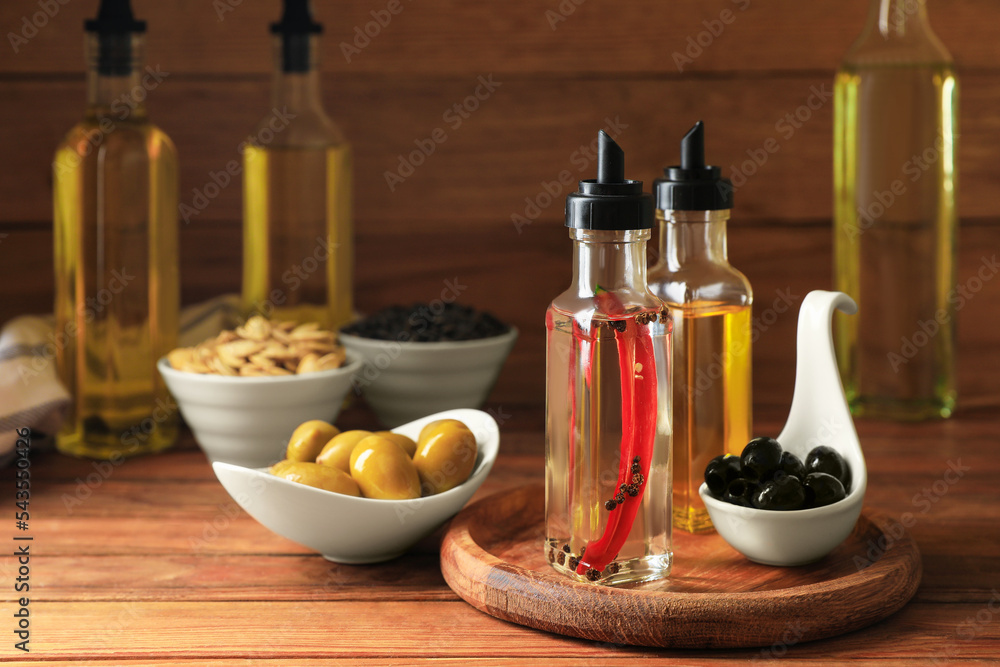 Different cooking oils and ingredients on wooden table Different cooking oils and ingredients on wooden table