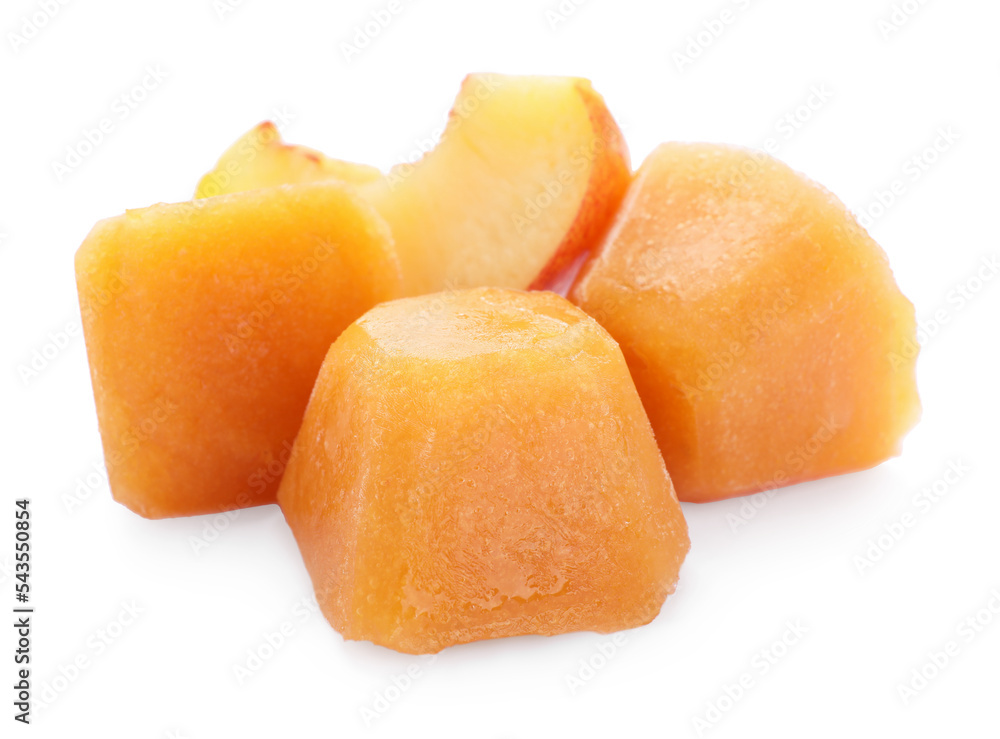 Frozen nectarine puree cubes and fruit on white background