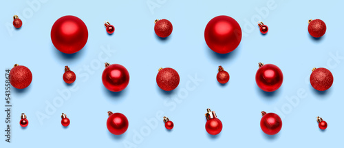 Red Christmas balls on light blue background. Pattern for design