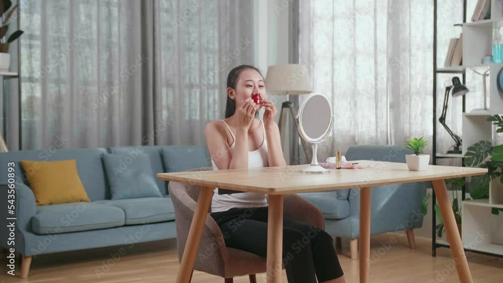 Beautiful Young Asian Woman Looks In The Mirror Using Collagen Lip Mask For Dry And Chapped Lips And Smiles While Taking Care Of Her Skin At Home
Beautiful Young Asian Woman Looks In The Mirror Using Collagen Lip Mask For Dry And Chapped Lips And Smiles While Taking Care Of Her Skin At Home