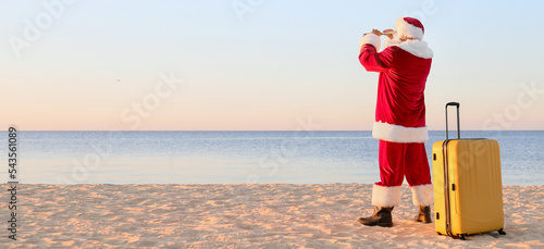 Santa Claus with suitcase a...