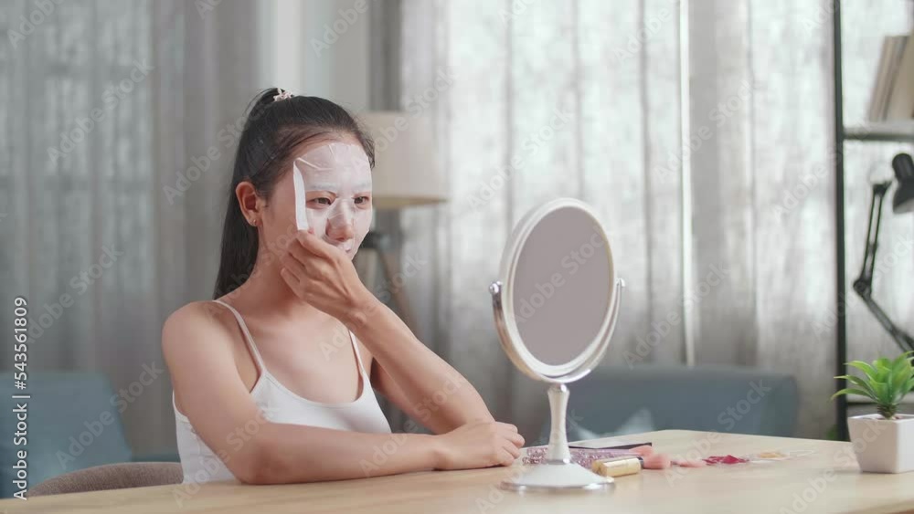 Beautiful Young Asian Woman Looks In The Mirror Taking Off Sheet Facial Mask, Touching Her Face, And Smiling While Taking Care Of Her Skin At Home
Beautiful Young Asian Woman Looks In The Mirror Taking Off Sheet Facial Mask, Touching Her Face, And Smiling While Taking Care Of Her Skin At Home