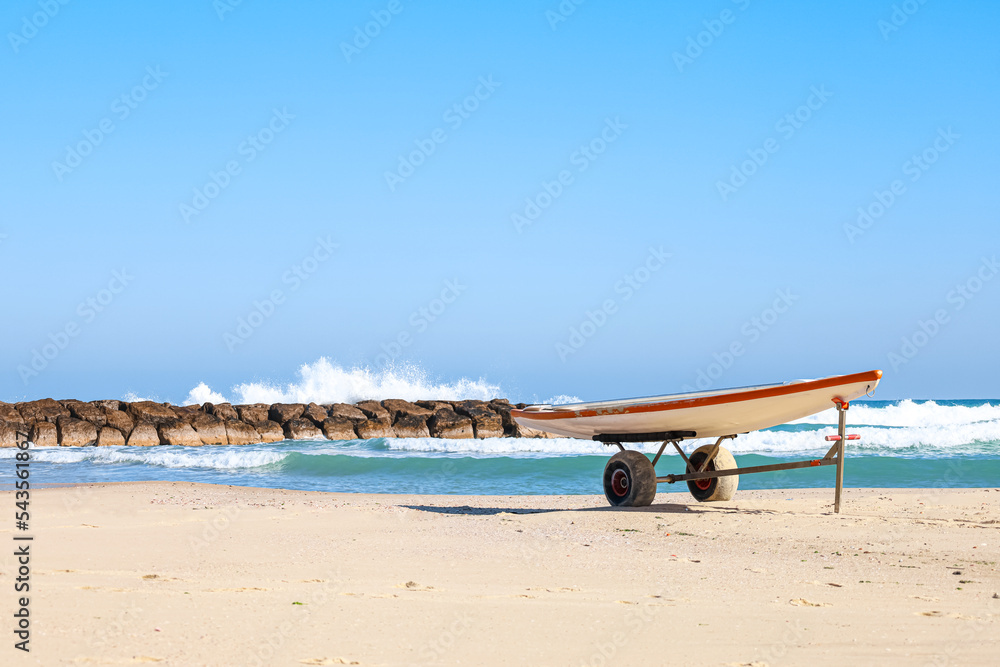 Modern boat on sand near sea Modern boat on sand near sea