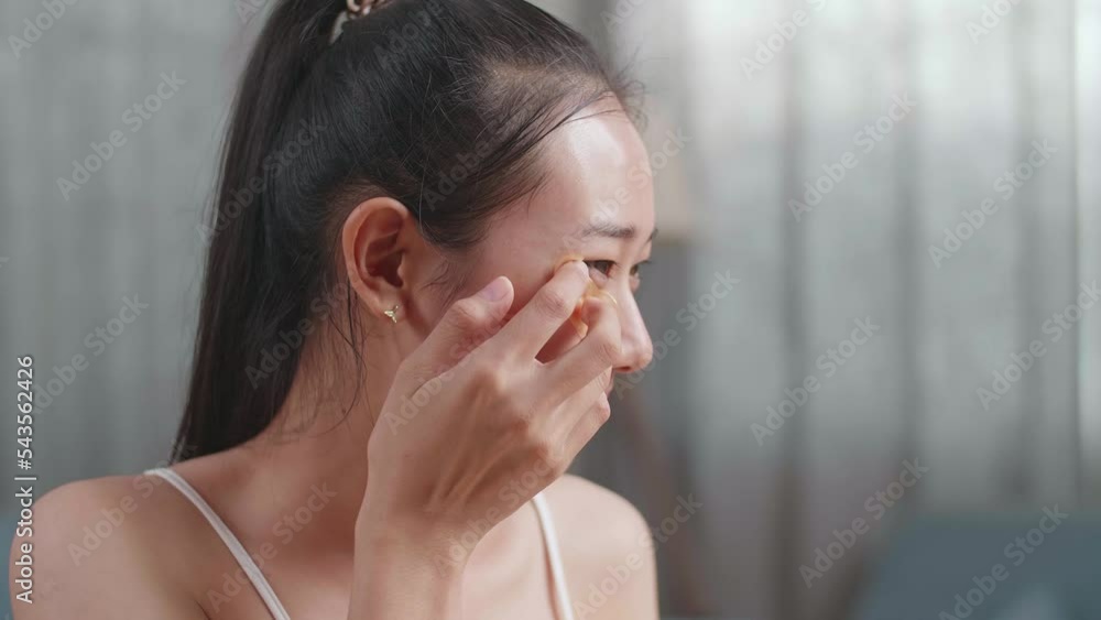 Close Up Of Beautiful Young Asian Woman With Cucumber Slices Looks In The Mirror Applying Under Eye Patches And Smiles While Taking Care Of Her Skin At Home
Close Up Of Beautiful Young Asian Woman With Cucumber Slices Looks In The Mirror Applying Under Eye Patches And Smiles While Taking Care Of Her Skin At Home