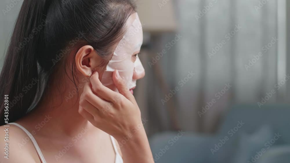 Close Up Of Beautiful Young Asian Woman With Cucumber Slices Looks In The Mirror Taking Off Sheet Facial Mask, Touching Her Face, And Smiling While Taking Care Of Her Skin At Home
Close Up Of Beautiful Young Asian Woman With Cucumber Slices Looks In The Mirror Taking Off Sheet Facial Mask, Touching Her Face, And Smiling While Taking Care Of Her Skin At Home