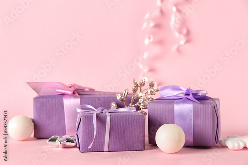 Beautiful Christmas gifts and decorations on pink background