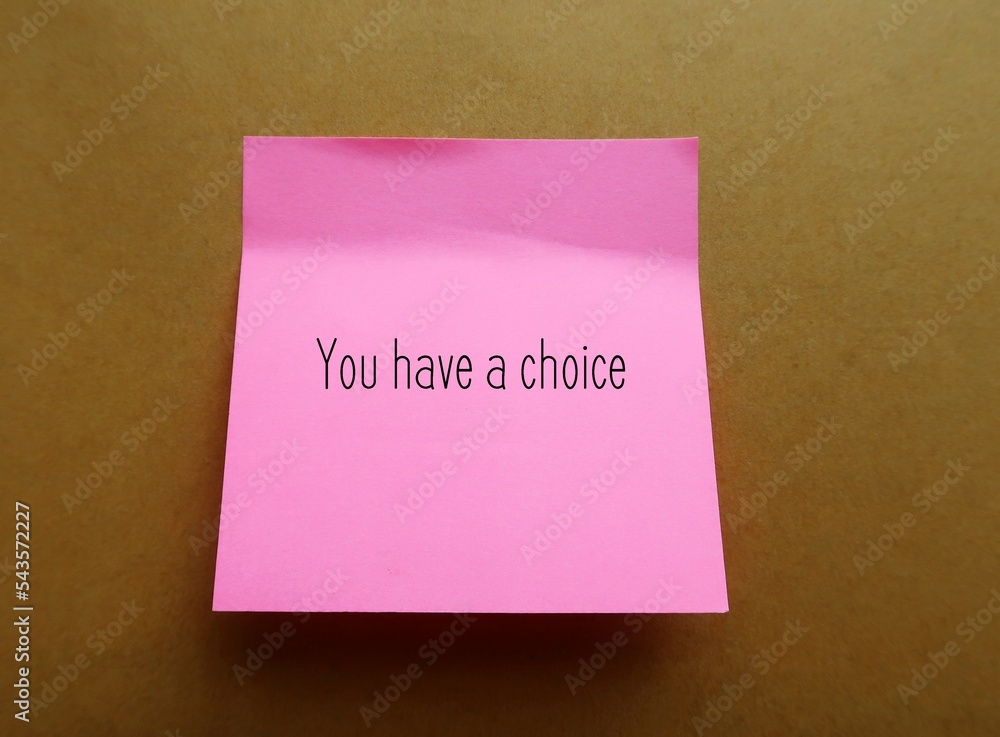 Pink note stick on office envelope with handwriting YOU HAVE A CHOICE, to remind self not to feel trapped, everyone have more choices available than realize in any given moment Pink note stick on office envelope with handwriting YOU HAVE A CHOICE, to remind self not to feel trapped, everyone have more choices available than realize in any given moment
