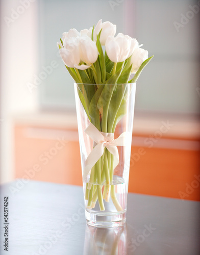 White tulips in the  glass vase. photo