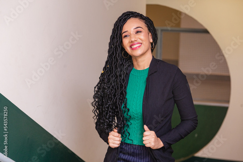 young black woman, brazilian, entrepreneur, businesswoman, smiling in office. photo