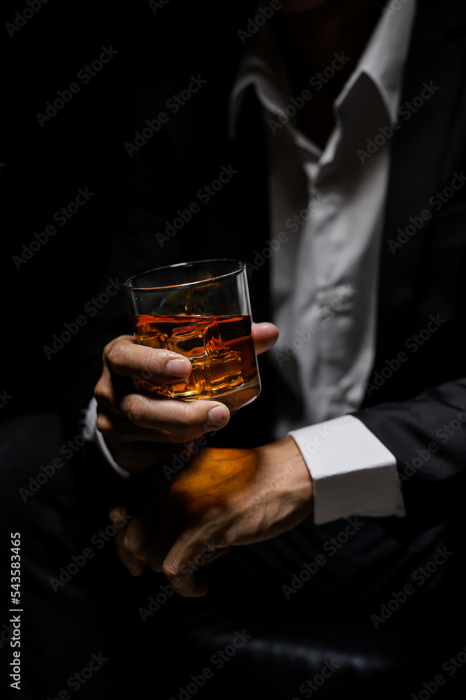 Closeup businessmen holding a glass of whiskey