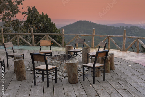 Fototapeta Naklejka Na Ścianę i Meble -  Many chairs and fire place under sunset against mountain view in Da Lat Vietnam