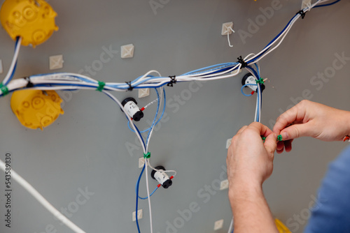 Electrician works cable checking energy