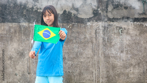 a little girl with the brazil flag