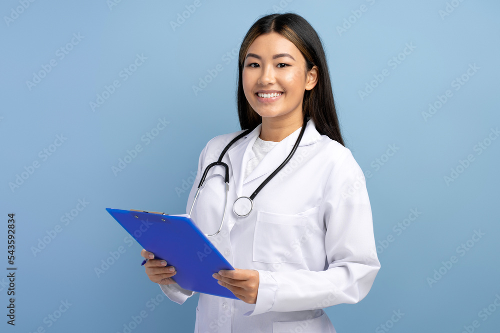 Asian doctor in white medical gown with stethoscope on shoulders taking notes Asian doctor in white medical gown with stethoscope on shoulders taking notes