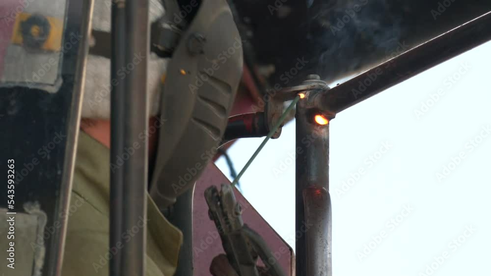 Welder Worker Performs Jump Welding. Worker Welder Performs ArcWelding