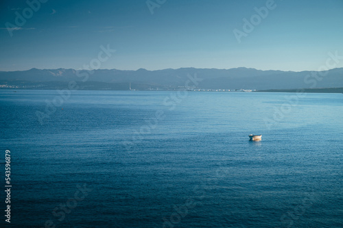 Alone Boat in clear blue Mediterranean sea. Summer Vacation photo. Edit space. photo