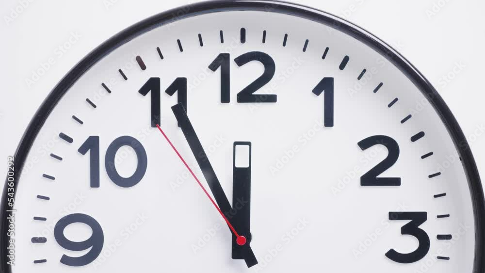 part of a round white wall clock with a red second hand on a white background. twelve o'clock part of a round white wall clock with a red second hand on a white background. twelve o'clock