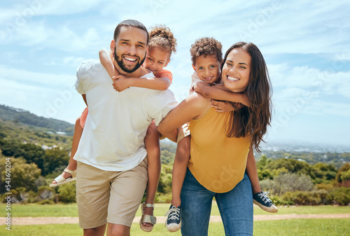 Fototapeta Happy mom, dad and children on piggyback ride from parents in nature park for fun, summer time bonding and outdoor family activity