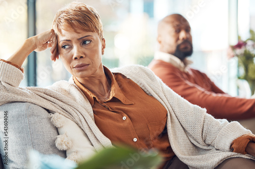 Mature couple, divorce and fighting on sofa in house, home living room or marriage counseling therapy. Stress, frustrated or depression for black woman and man in psychology counselling for cheating photo