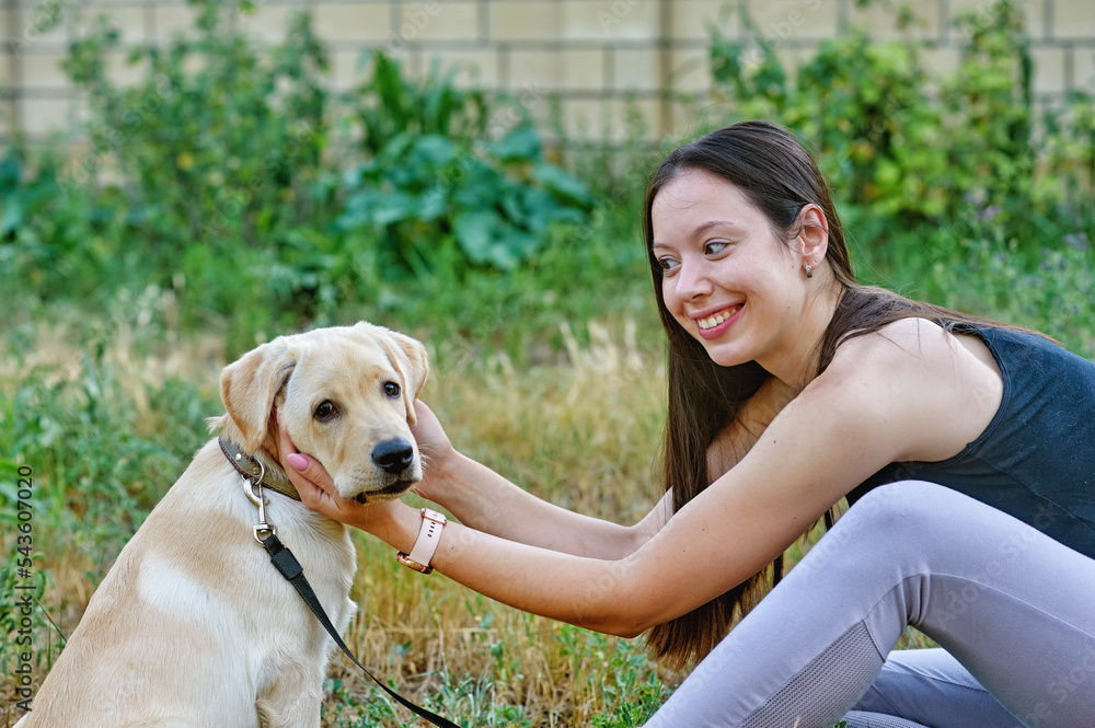 young woman with her lovely dog on a summer day