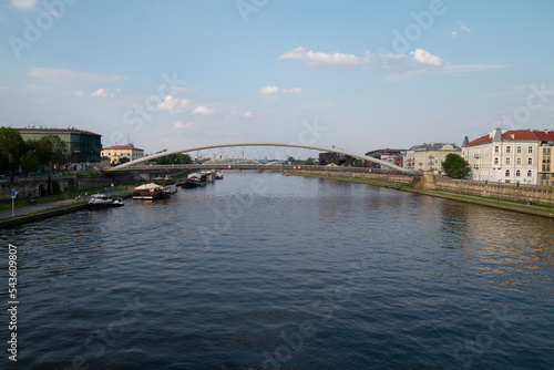 Vistula River (Wisła) in Krakow, Poland. Vistulan Boulevards with Father Bernatek’s pedestrian and bicycle bridge (Kładka Ojca Bernatka Kraków), connecting Kazimierz with Podgórze. photo