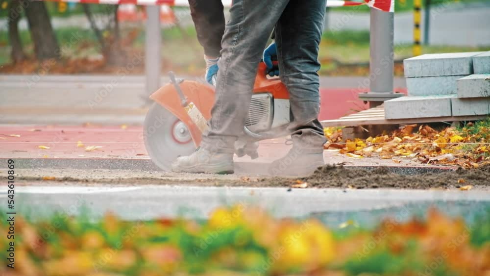 Roadworks Construction Worker Operating Tarmac Circular Saw Cutting Asphalt on Busy Street Roadworks Construction Worker Operating Tarmac Circular Saw Cutting Asphalt on Busy Street