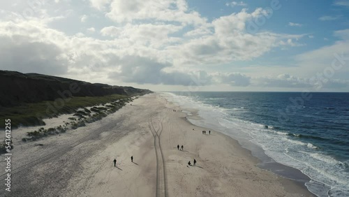 Aerial view of beach. Sylt, Germany, Schleswig-Holstein.  Beautiful sea waves. Sand and amazing sea. Summer seascape. North Sea. Atlantic Ocean beach. Water texture. 4K drone