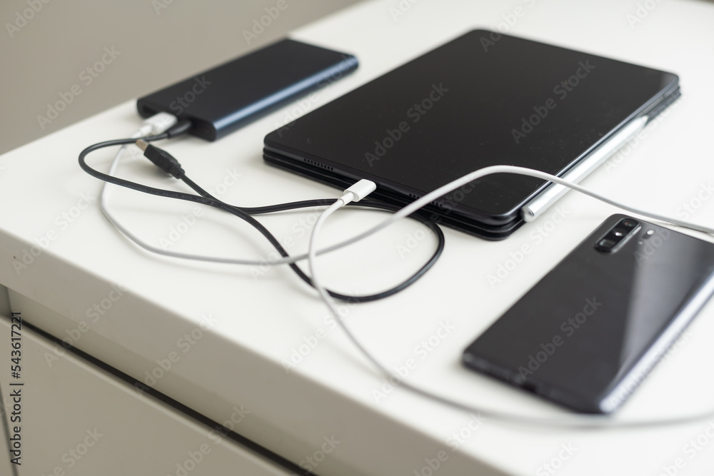 USB charging cables for smartphone and tablet in top view. USB charging cables for smartphone and tablet in top view.
