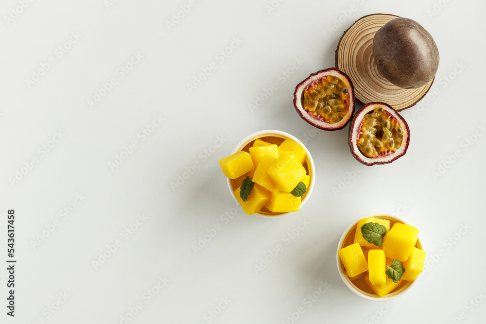 A plate with yellow passion fruit jelly candies on a white background. copy space A plate with yellow passion fruit jelly candies on a white background. copy space