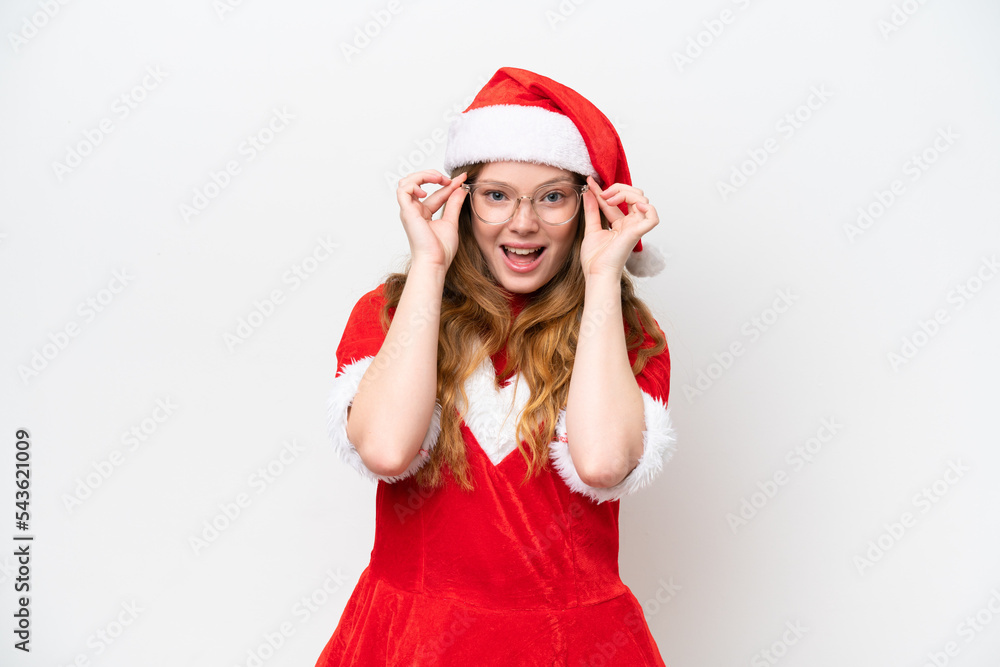 Young caucasian woman with Christmas dress isolated on white background with glasses and surprised Young caucasian woman with Christmas dress isolated on white background with glasses and surprised